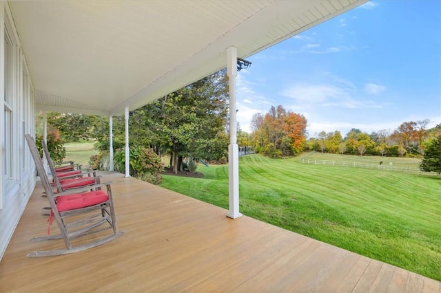 wooden terrace featuring a yard