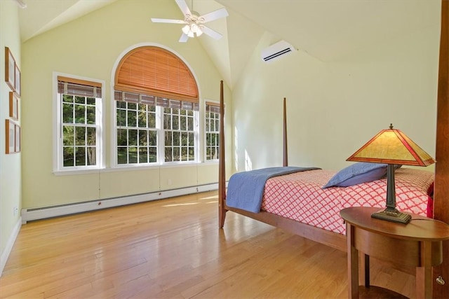 bedroom featuring a wall mounted air conditioner, high vaulted ceiling, ceiling fan, baseboard heating, and light hardwood / wood-style floors