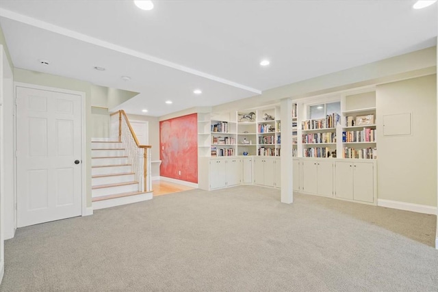 basement with light carpet and built in shelves