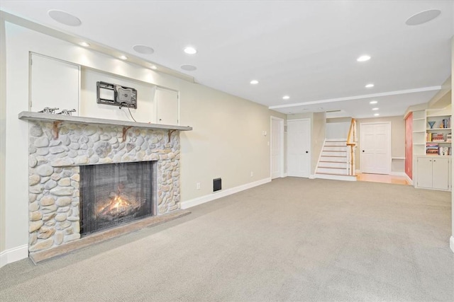 unfurnished living room with light colored carpet and a fireplace