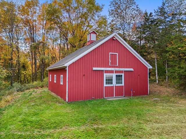 view of outbuilding with a lawn