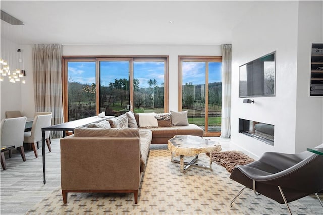 living room with light wood-type flooring and plenty of natural light