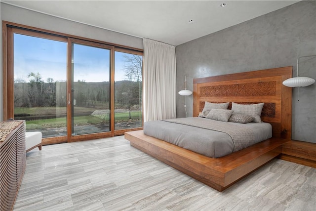 bedroom featuring light hardwood / wood-style floors and access to outside