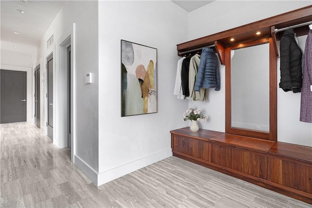 mudroom with light hardwood / wood-style floors