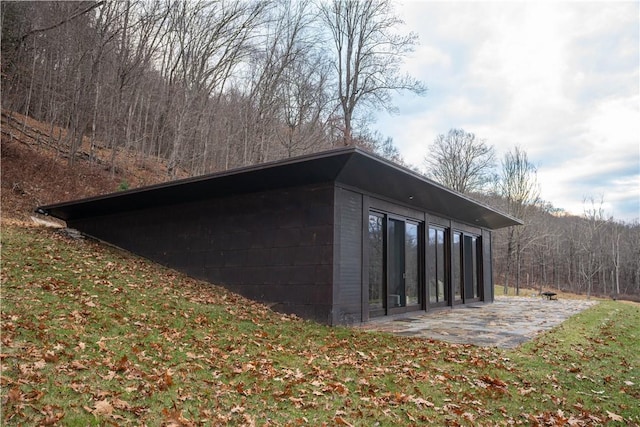 view of outbuilding with a lawn