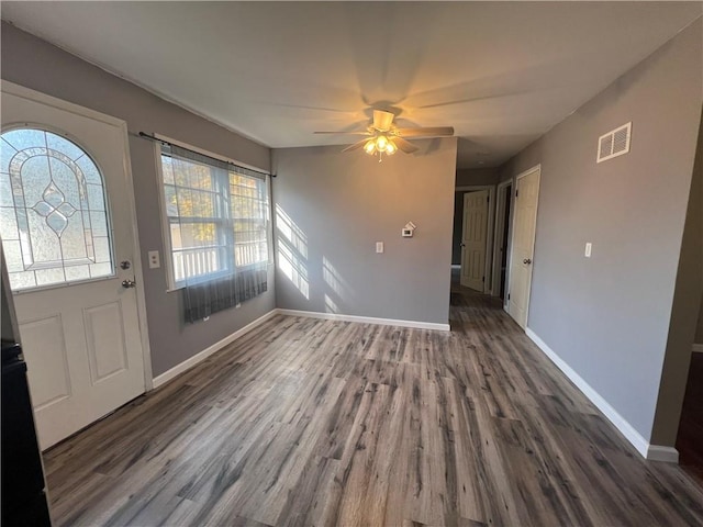 entrance foyer with ceiling fan and dark wood-type flooring