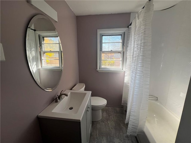 full bathroom with shower / bathtub combination with curtain, vanity, toilet, and wood-type flooring