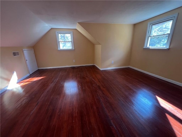 bonus room with dark hardwood / wood-style floors and lofted ceiling