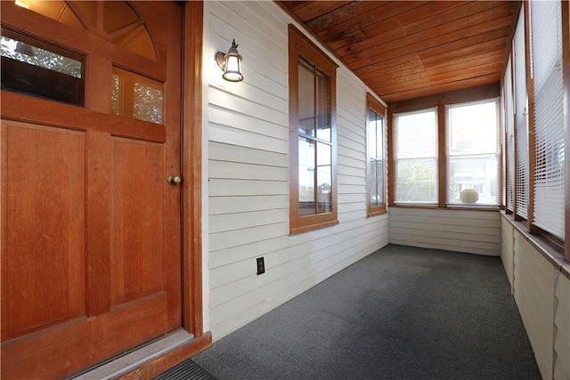 unfurnished sunroom featuring wooden ceiling