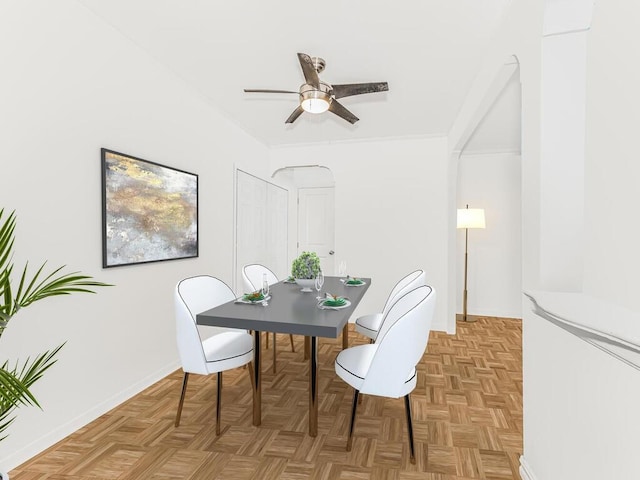 dining room featuring ceiling fan and light parquet flooring