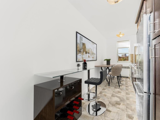 interior space with radiator heating unit and vaulted ceiling