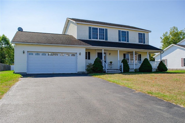 view of front of property featuring a front lawn, a porch, and a garage