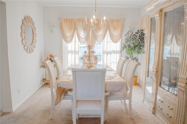 dining space featuring a notable chandelier and light colored carpet