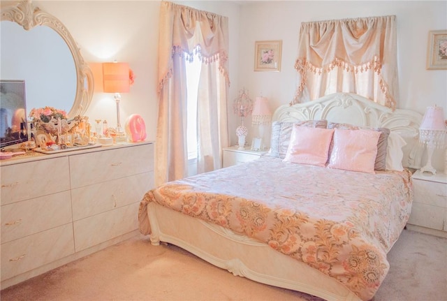 bedroom with carpet floors and multiple windows