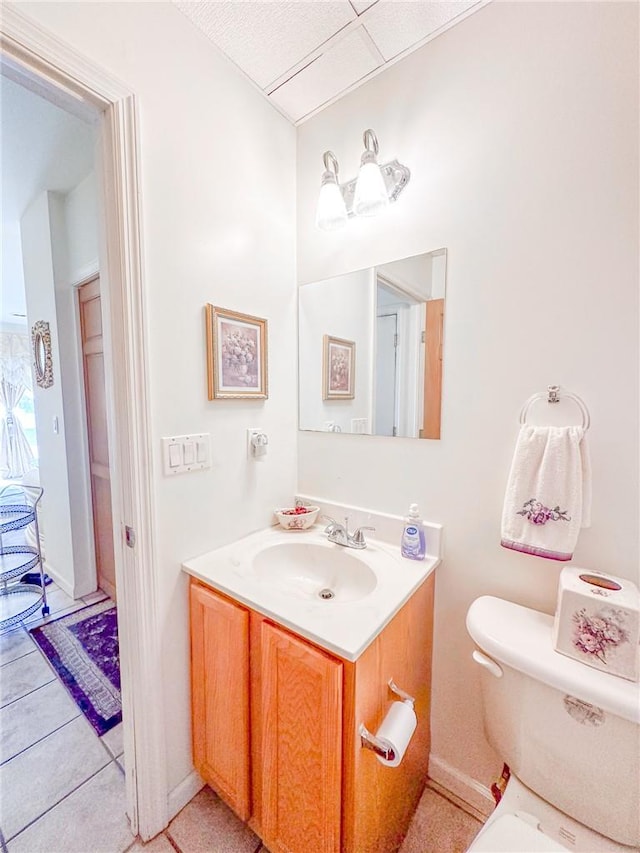 bathroom with tile patterned flooring, vanity, and toilet