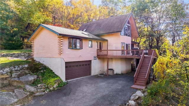 356 Nimham Rd, Carmel, NY 10512 - view of front of house featuring stairs, a wooden deck, a garage, asphalt driveway, and log siding
