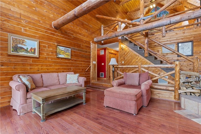 living room with wood-type flooring, high vaulted ceiling, wooden ceiling, and beam ceiling