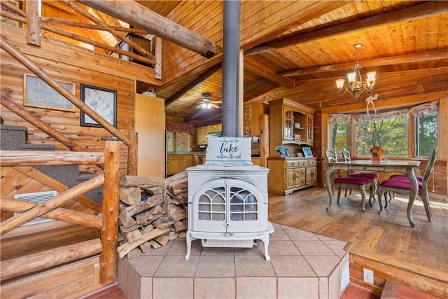 356 Nimham Rd, Carmel, NY 10512 - dining space featuring a wood stove, wood ceiling, a chandelier, wood finished floors, and stairway