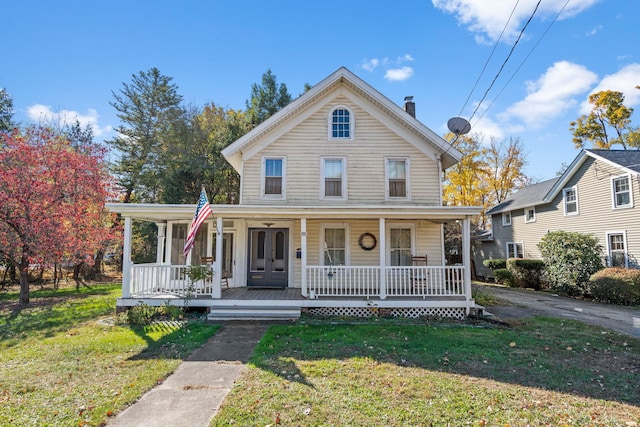 view of front of home with a porch and a front yard