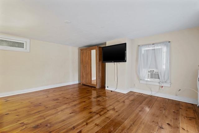 spare room featuring hardwood / wood-style flooring and cooling unit