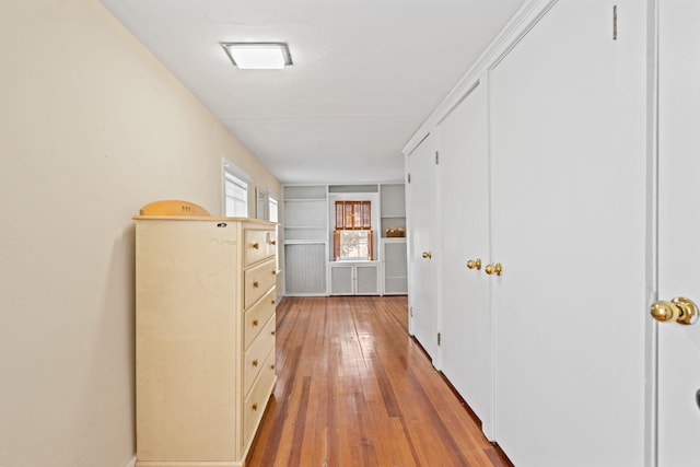 corridor with hardwood / wood-style flooring