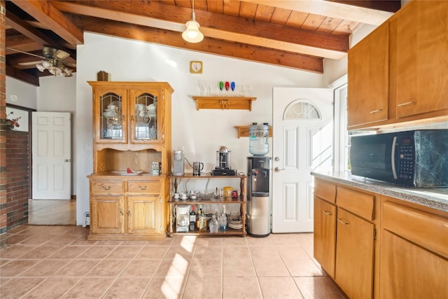 kitchen with lofted ceiling with beams, ceiling fan, wood ceiling, and light tile patterned floors