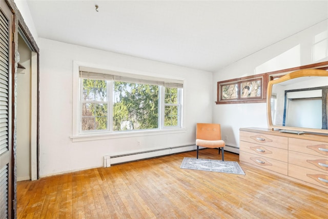 sitting room featuring hardwood / wood-style floors and a baseboard radiator