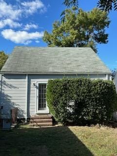 view of side of home with a lawn and entry steps