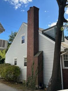 view of side of home featuring a chimney