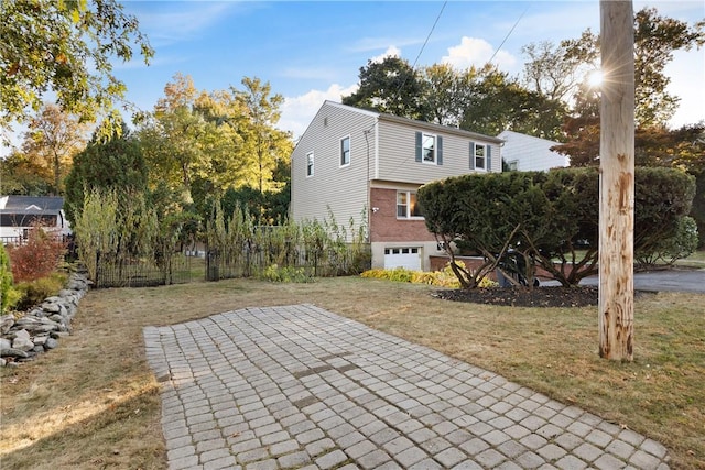 back of property with a garage, a yard, and a patio