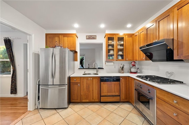 kitchen with stainless steel appliances, light hardwood / wood-style flooring, and sink