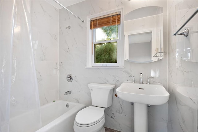 bathroom featuring shower / tub combo, toilet, and tile walls