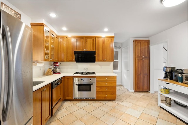 kitchen with light tile patterned flooring and appliances with stainless steel finishes