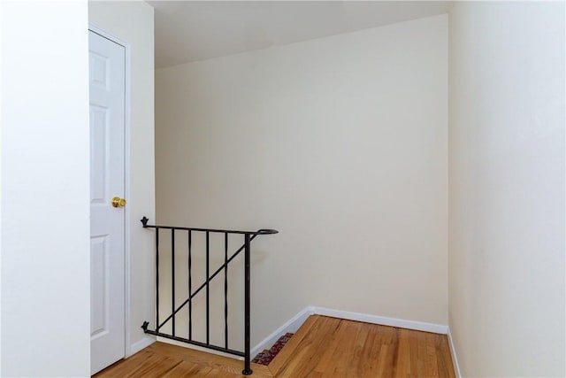 staircase with hardwood / wood-style floors