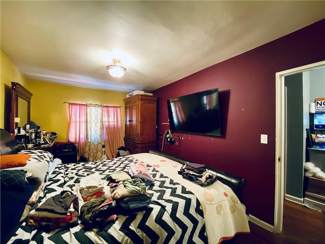 bedroom with dark wood-type flooring