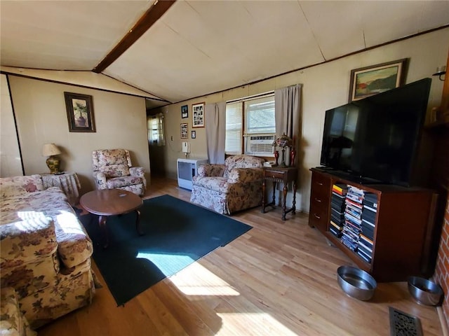 living room with vaulted ceiling with beams and light hardwood / wood-style flooring