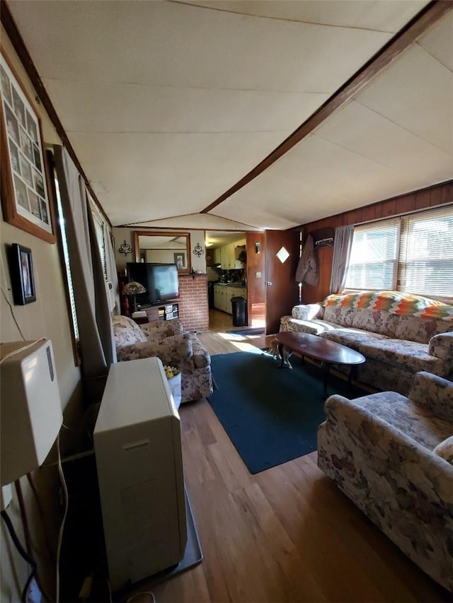 living room with lofted ceiling and hardwood / wood-style flooring