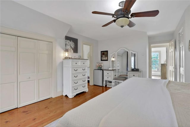 bedroom with ceiling fan, a closet, and hardwood / wood-style flooring