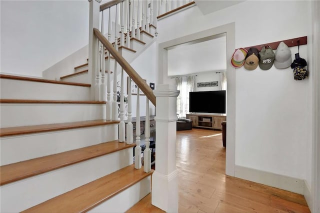 staircase with wood-type flooring