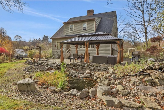 rear view of property with a gazebo and a patio area