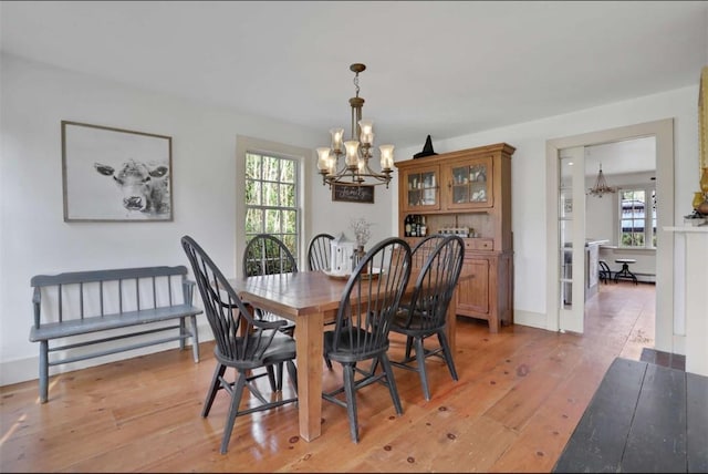 dining space featuring a chandelier and light hardwood / wood-style floors