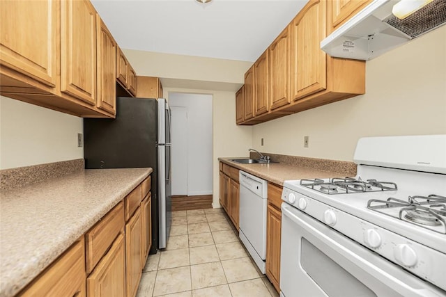 kitchen with sink, white appliances, and light tile patterned flooring