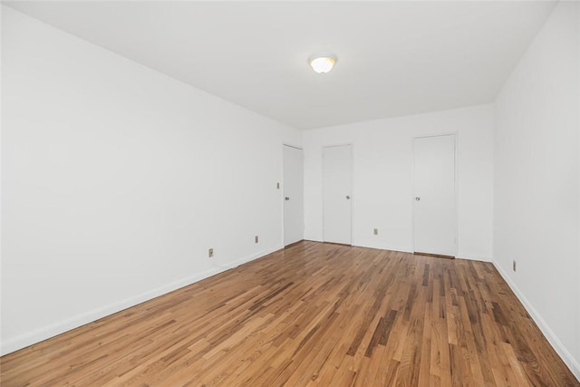 empty room with wood-type flooring