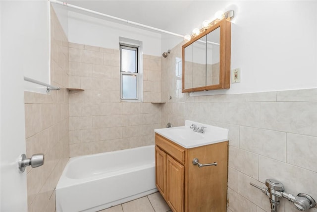 bathroom featuring tile walls, vanity, tile patterned floors, and tiled shower / bath