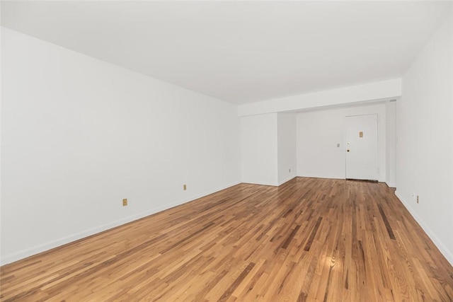 spare room featuring light hardwood / wood-style flooring