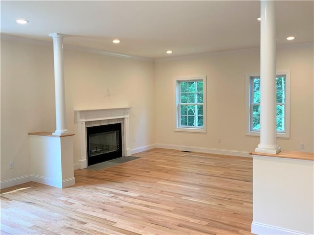 unfurnished living room with light wood-type flooring and ornamental molding