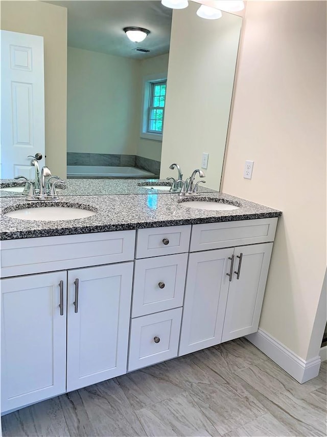 bathroom featuring vanity and a tub to relax in