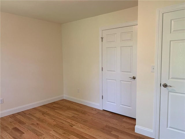 empty room with hardwood / wood-style floors