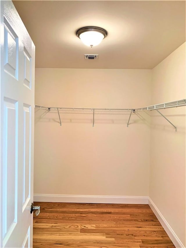 spacious closet featuring hardwood / wood-style floors