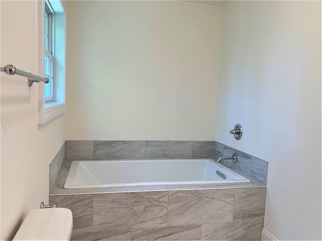 bathroom with tiled bath